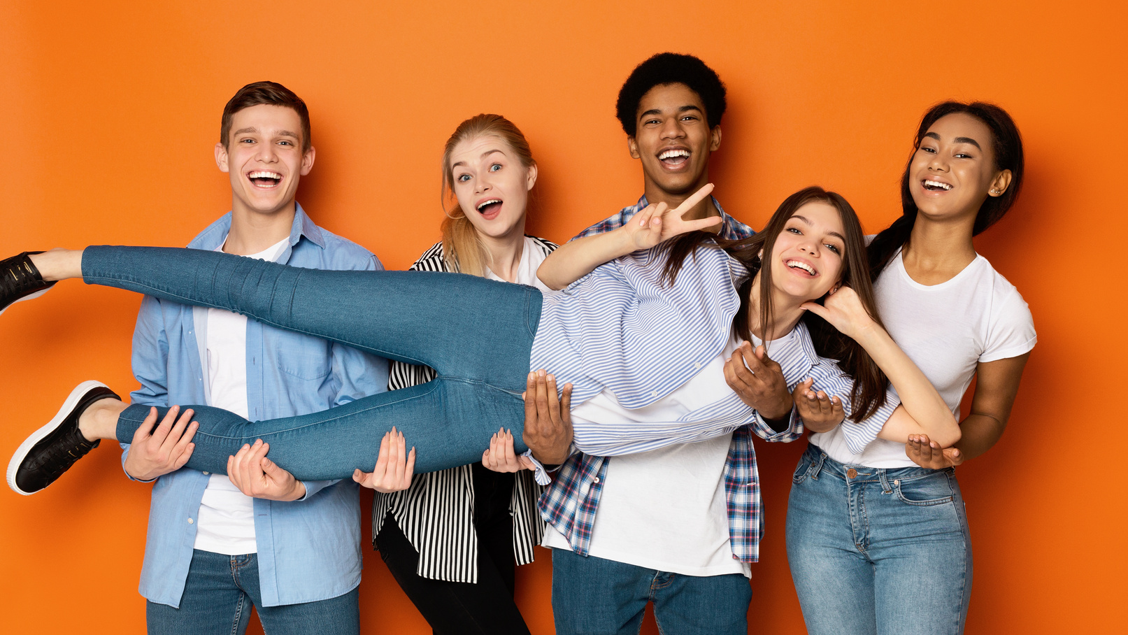 Youth and friendship. Teens holding friend and posing